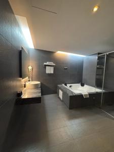 a bathroom with a large tub and a sink at Imperial Dynasty Boutique Hotel in Dounan +24 photos