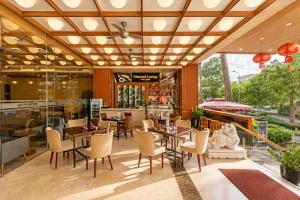 a restaurant with wooden ceilings and tables and chairs at G8 Diamond Hotel Saigon in Ho Chi Minh City
