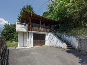 a small house with a balcony and a staircase at Holiday Home Chalet Guldeli by Interhome in Kandergrund