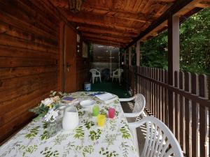 a table on the back porch of a house at Holiday Home Chalet Guldeli by Interhome in Kandergrund