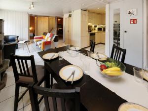 a dining room with a table with a bowl of fruit on it at Holiday Home Chalet Guldeli by Interhome in Kandergrund