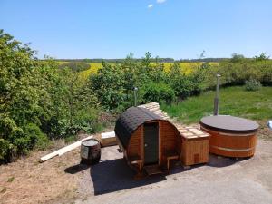 a small wooden house with a tire on it at Vinum Vivo winery in Nevidzany +2 photos