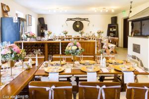 a long table in a room with flowers on it at Vinum Vivo winery in Nevidzany