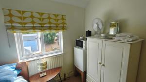 a bedroom with a bed and a window at 15 Aller Park Rd, Newton Abbot in Newton Abbot