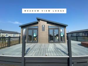 a modular tiny house on a wooden deck at Meadow View Lodge in Tattershall +3 photos