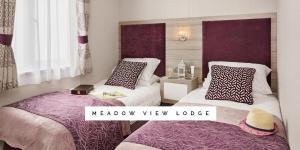 a bedroom with two beds and a meadow view lodge at Meadow View Lodge in Tattershall