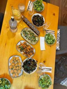 a wooden table with many plates of food on it at Casa Bianca - Summer residency in Primorsko