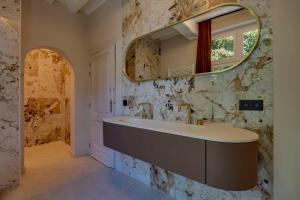 a bathroom with a sink and a mirror at Boutique hotel Roosendaelhof in Geel +52 photos