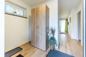 a large wooden cabinet in a living room with a vase at Ferienwohnung Unterlechner - Apt 3 in Vomp