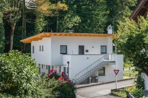 a white house with a staircase on the side of it at Ferienwohnung Unterlechner - Apt 3 in Vomp