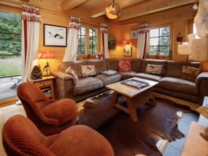 a living room with a couch and chairs and a table at Chalet Dörfli by Interhome in Les Diablerets