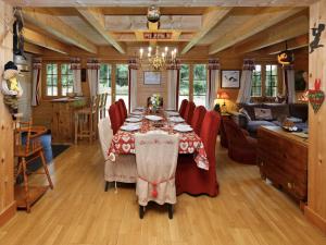 a dining room with a table and red chairs at Chalet Dörfli by Interhome in Les Diablerets +29 photos