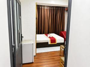 a small room with a bed and a window at Hồng Phát 68 Hotel in Ho Chi Minh City