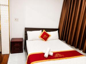 a bedroom with a bed with a stuffed animal on it at Hồng Phát 68 Hotel in Ho Chi Minh City