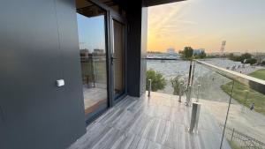 a balcony with a large window and a view at Maskan Premium Hotel Tashkent in Aktepa-Chigatay