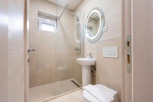 a bathroom with a shower and a toilet and a sink at Apartments Bečić in Budva
