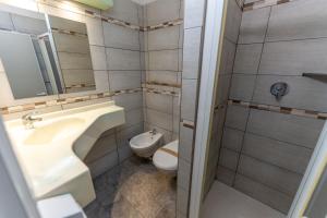 a bathroom with a sink and a toilet at Hotel Villa Itala in Rimini