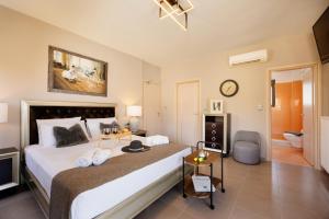 a bedroom with a large bed and a bathroom at Lamon Villa in Plakias +93 photos