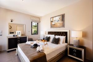 a bedroom with a large bed with towels on it at Lamon Villa in Plakias