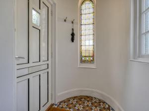 a white hallway with a door and a window at Holiday Home Sullivan by Interhome in Drumnadrochit +59 photos