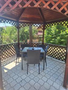 a wooden gazebo with a table and chairs on a patio at Marilyn Apartment in Nitra