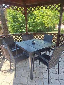 a blue table and chairs under a gazebo at Marilyn Apartment in Nitra