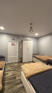 a room with two beds and a door in it at شقة وقف الخير اسبوعي وشهري Charity apartment, weekly and monthly in Medina