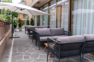a row of chairs and tables on a sidewalk at Hotel Villa Itala in Rimini