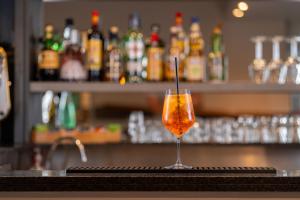 a wine glass sitting on top of a bar at Hotel Villa Itala in Rimini +30 photos