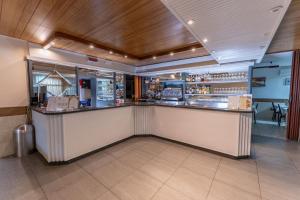 a bar in a restaurant with a counter at Hotel Villa Itala in Rimini