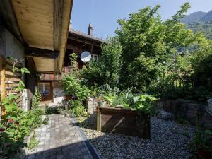 a garden in front of a house at Apartment Beim Thor Klein by Interhome in Brienzwiler