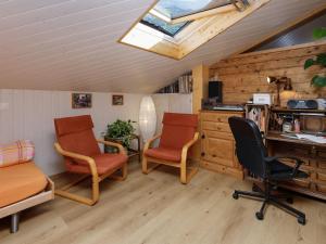 a room with two chairs and a desk and a skylight at Apartment Beim Thor Klein by Interhome in Brienzwiler +14 photos