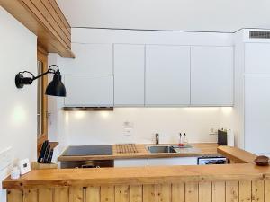 a kitchen with white cabinets and a sink at Apartment Le Sporting 213 by Interhome in Champex +28 photos