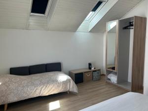 a bedroom with two beds and a mirror in it at Maison indépendante Anna in Wittenheim