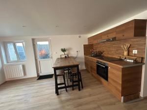 a kitchen with a table and a counter top at Maison indépendante Anna in Wittenheim