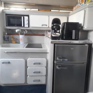 an rv kitchen with a stove and a sink at Bateau 66 in Le Barcarès