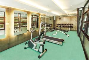a gym with treadmills and elliptical machines at Diamond Residence Ratchada in Bangkok