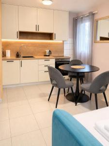 a kitchen with a table and chairs in a room at Split Old Town Rooms Matushko in Split