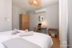 a bedroom with a white bed and a desk at Gîte LE VAUBAN - Mon Gîte Facile in Colmar