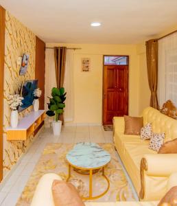 a living room with a couch and a table at JVV Bright Suites BnB in Eldoret