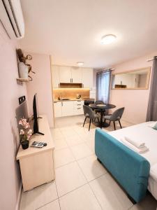 a living room with a blue couch and a kitchen at Split Old Town Rooms Matushko in Split