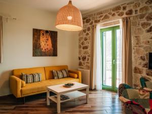 a living room with a couch and a table at Petra & Thalassa in Plataria