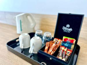 a black lunch box with cigarettes and drinks in it at Level 20 King Bed Suite with Ocean Views in Gold Coast
