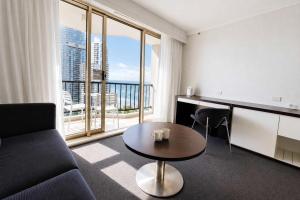 a living room with a couch and a table at Level 20 King Bed Suite with Ocean Views in Gold Coast