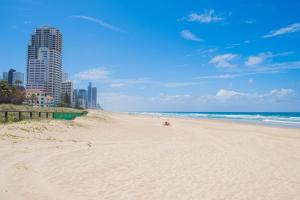 a sandy beach with a city in the background at Level 20 King Bed Suite with Ocean Views in Gold Coast