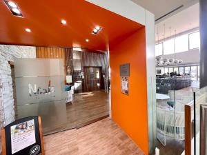 an orange wall in a room with a kitchen at Level 20 King Bed Suite with Ocean Views in Gold Coast +3 photos