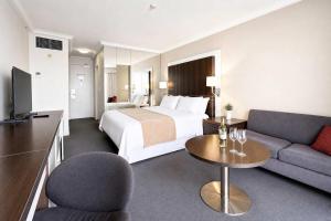 a hotel room with a bed and a couch at Level 20 King Bed Suite with Ocean Views in Gold Coast