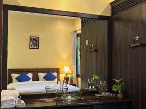 a bedroom with a bed and a bathroom with a sink at Inthira Thakhek in Thakhek