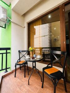 a table and two chairs sitting on a balcony at Historic Centre Apartment Kutaisi in Kutaisi +25 photos