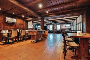 a dining room with wooden walls and tables and chairs at Hotel Gut Funkenhof in Sundern
